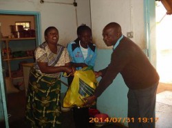 MOPH 011 A guidance teacher from Livingstone Basic school donates washing paste on behalf of the girls as a way of supporting the home