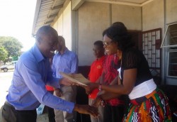 caleb being awarded Caleb Chabauni(RN buildings Officer) being awarded by the District Commissioner